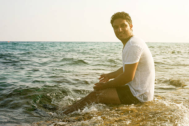 istock Arabian man enjoying on the beach. 614868114