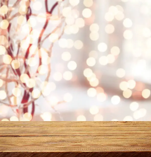 Photo of Defocused Christmas light and wooden background