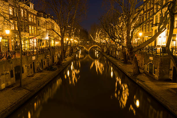 Utrecht, The Netherlands- March 14, 2016: The city of Utrecht at night, Oude Gracht, bridge, houses, canal and restaurants.
