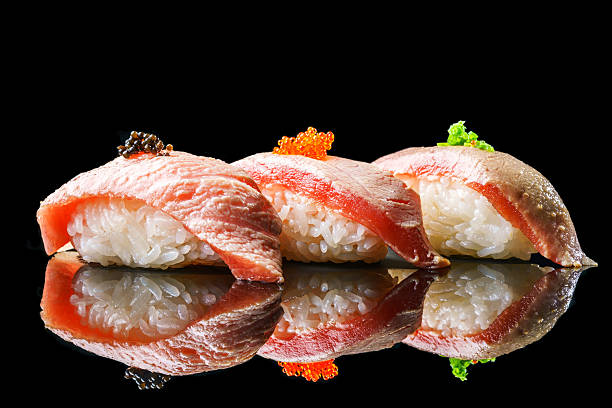 salmon sushi on the blackbackground - sushi sashimi nigiri salmon imagens e fotografias de stock