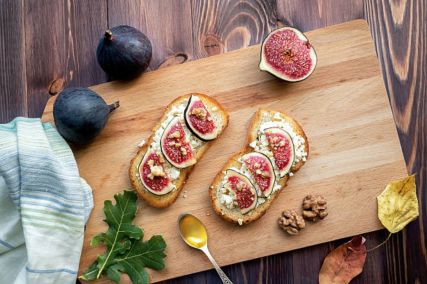 istock Figs toast on wooden background 614871094