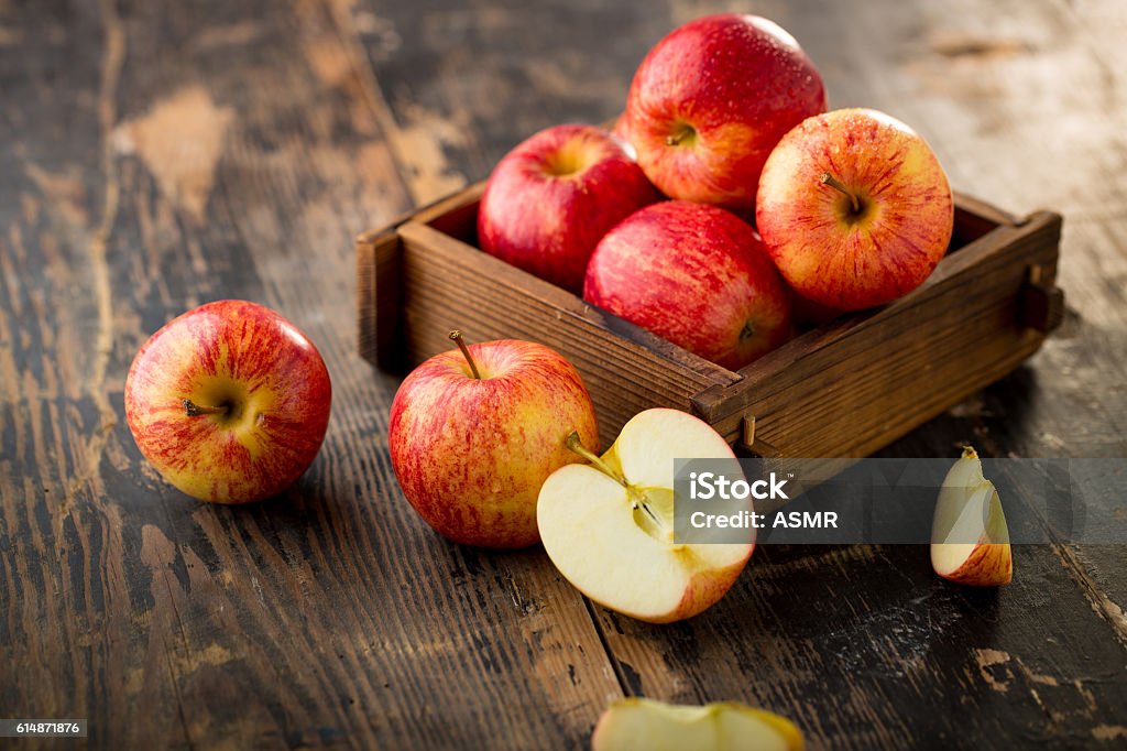 apple isolated on wood background Apple - Fruit Stock Photo