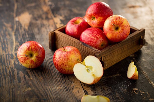 apple isolated on wood background stock photo