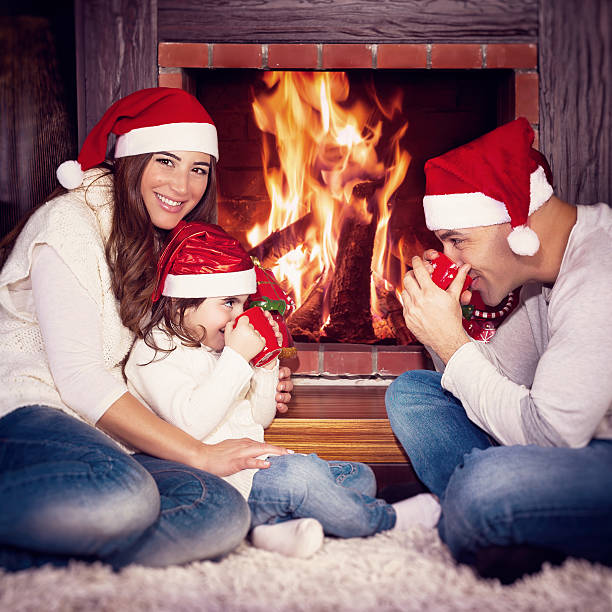 istock Happy family near fireplace 614872272