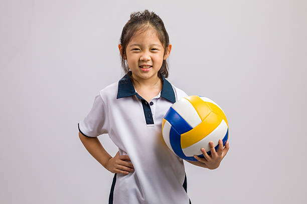 istock Child Holding Ball, Isolated on White 614874460