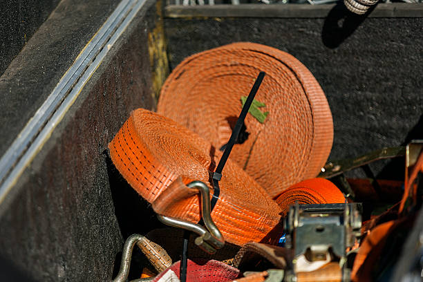 istock Box with tools and hanks of ribbon tow rope belts 614874858