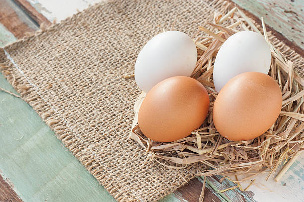 istock Organic eggs on vintage wooden background. 614875046