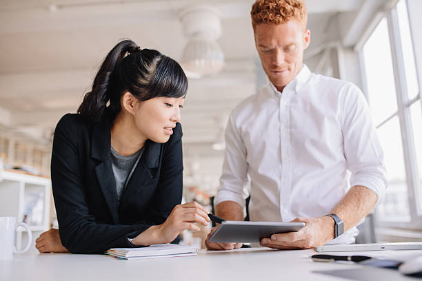 istock Business people working together on digital tablet 614875202