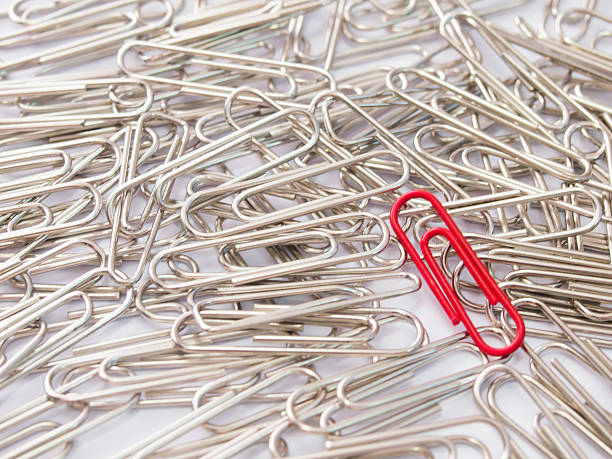 istock Red paper clip stand different from the crowd 614875886