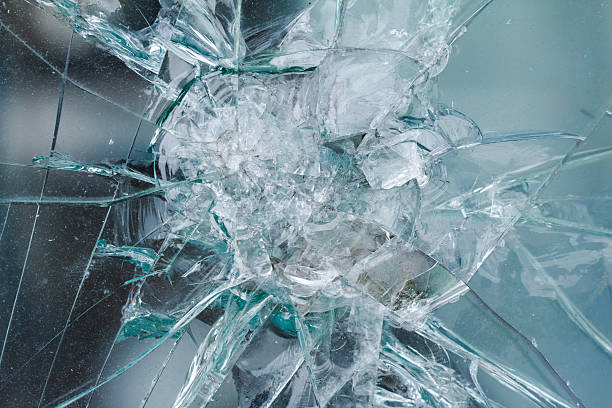 istock Firearms bullethole on bulletproof glass, cracks background 614875996