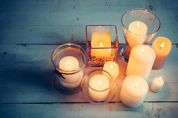 istock Christmas candles on a white wooden background 614876050