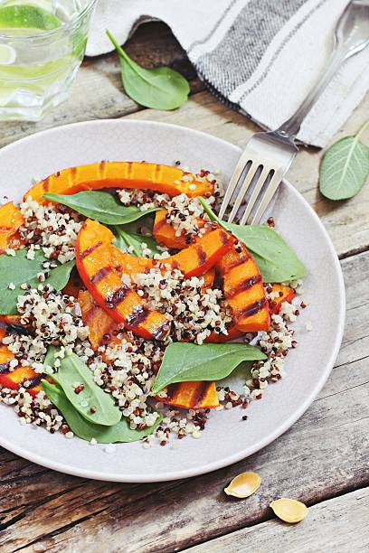 istock Quinoa salad with grilled pumpkin and fresh spinach 614876064