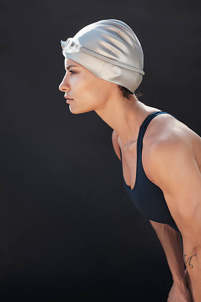 istock Focused young woman in swimsuit looking away 614876488