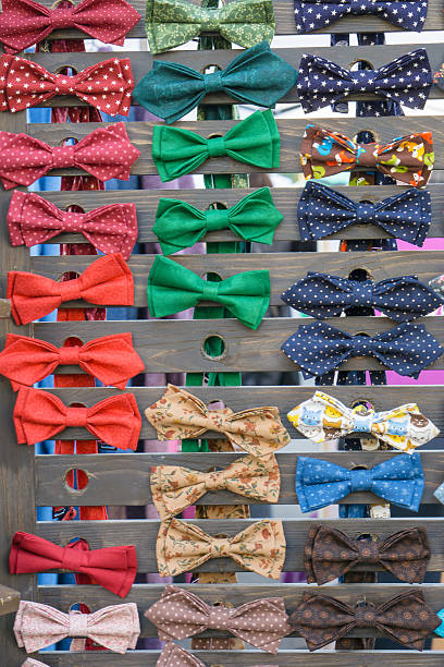 istock lot of different colored bow tie, bowtie on wooden deck 614876952