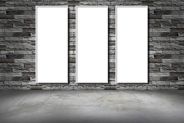 istock white frame on a brick wall and the concrete floor 614879586
