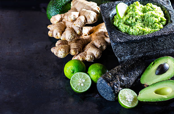 istock Latinamerican mexican guacamole with avocado ginger, lime in stone mortar 614880028