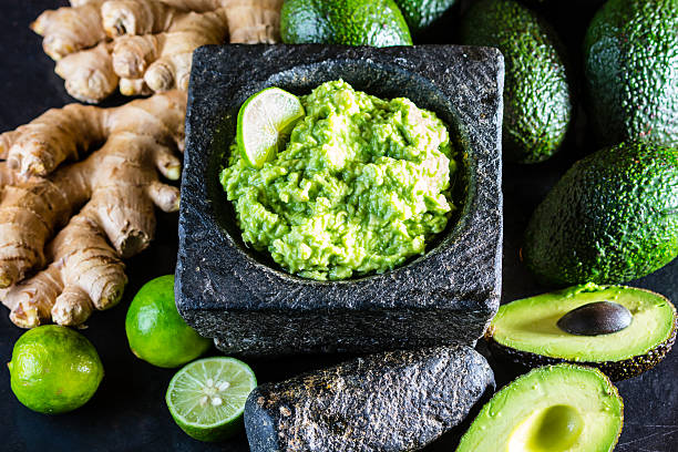 istock Latinamerican mexican guacamole with avocado ginger, lime in stone mortar 614950336