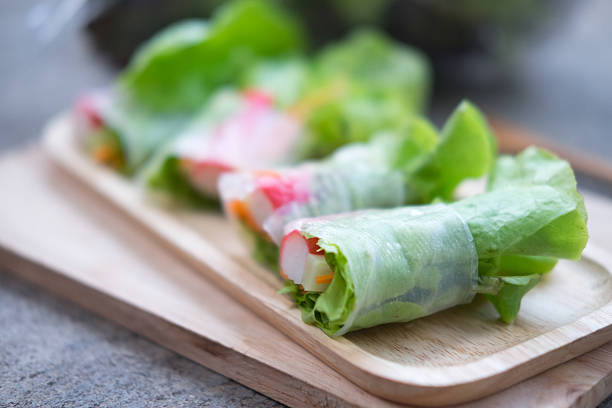 istock Vegetable salad roll on wood tray. Selective focus 614950354
