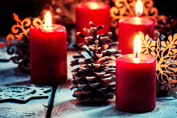 istock Red candles and pine cones with snowflakes 614950650