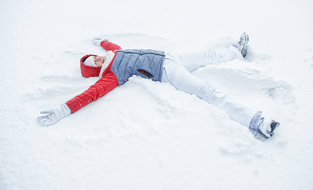istock Happy woman having fun on snow in winter 614952782