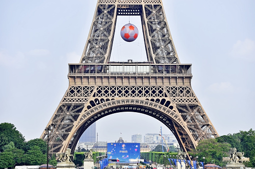 Paris, France - June 8, 2016: Giant soccer ball suspended on the Eiffel Tower during the UEFA 2016 European Championship in Paris.