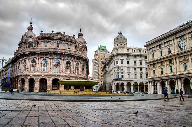 Genova, Italy, december 2 2013:  few people walk in the empty De Ferrari square in Genoa, Liguria, during winter season