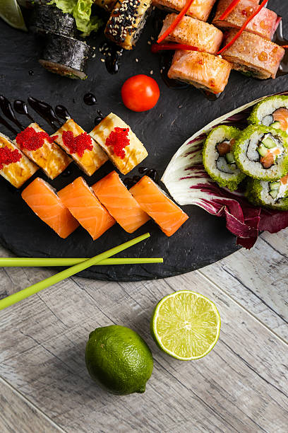 istock Big sushi set, the hand that holds the chopsticks 614955576