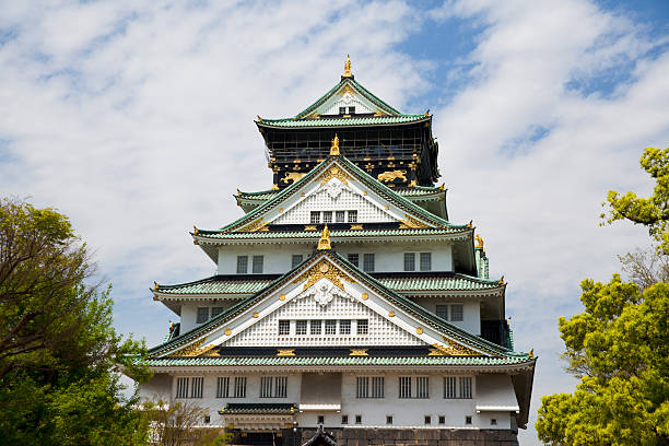Osaka,Japan - April 21 ,2015 : Osaka Castle on the bright blue sky day in Osaka, Japan on April 21,2015. The castle is one of Japan's most famous landmarks and it played a major role in the unification of Japan during the sixteenth century of the Azuchi-Momoyama period.