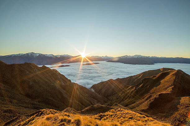 istock Last sun over the clouds from mountain peak 614958860