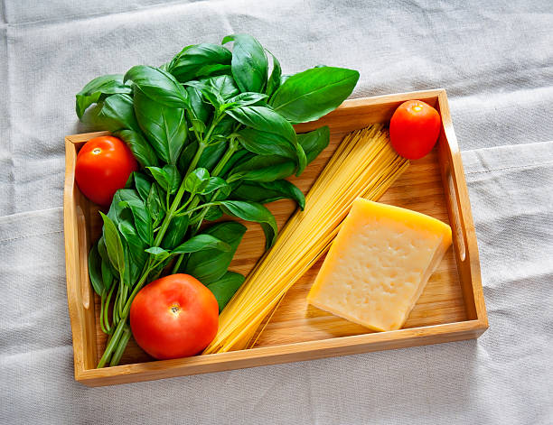 istock Green basil, chunk of parmesan cheese, raw cappellini and tomatoes 614959150