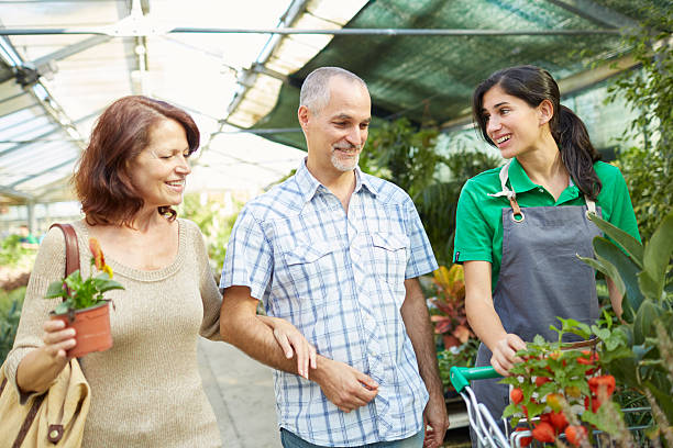 istock Middle aged couple buying in a plant nursery. 614960196