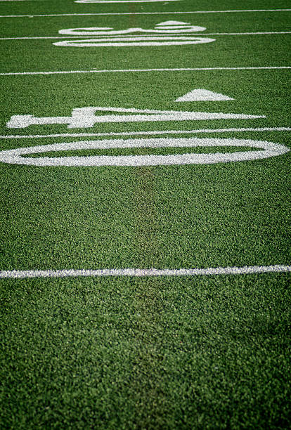 green grass football soccer field forty yardline - thirty yard line photos et images de collection