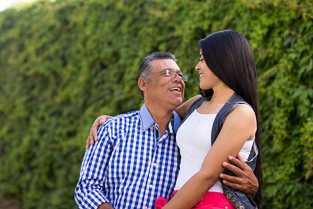 istock Latin father and daughter embracing and smiling 614960696