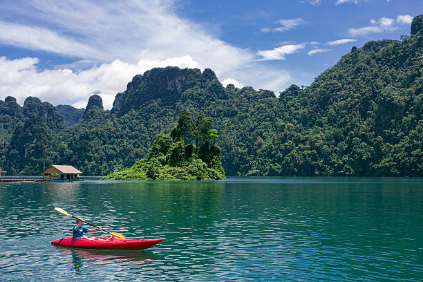 Rowing with a kayak in Kao Sok National Park lake Rowing with a kayak in Kao Sok National Park lake. kao sok national park stock pictures, royalty-free photos & images