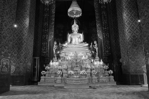 Bangkok, Thailand - October 12, 2016 : Back and white style image of golden Buddha statue and thai art architecture in Wat Bovoranives, Bangkok, Thailand.
