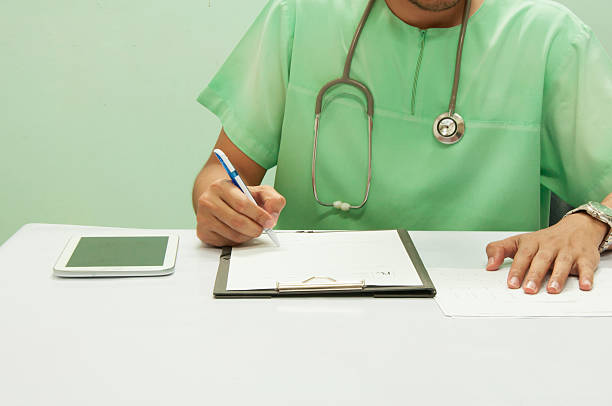 istock Doctor writing a medical prescription. 614962658