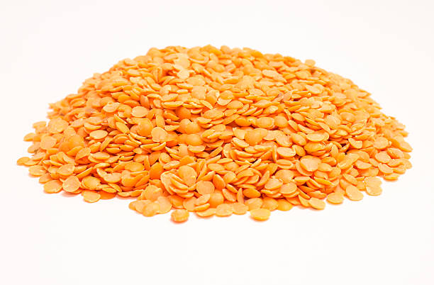 istock the seeds of red lentils on the white background 614965096