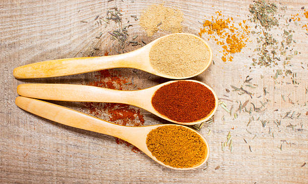istock Spice powder on a wooden background. Paprika, curry and ginger. 614967414