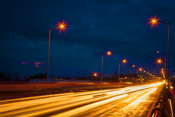 istock Vehicle light trails at night on highway 614967680