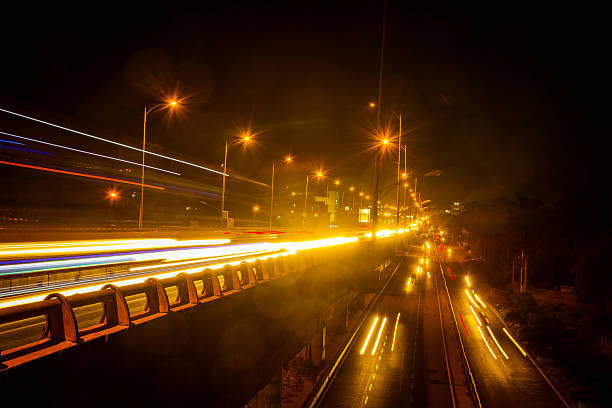 istock Vehicle light trails at night on highway 614967872