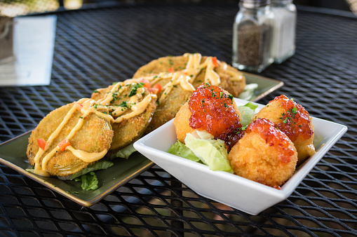 Fried green tomatoes and fried fritters are served as appetizers.