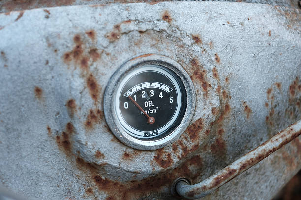 Coalport, Shropshire, England, UK - May 02, 2018: An old disused petrol pump in front of a hedge
