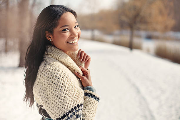 Beautiful young woman in the snow in winter Girl walking around in a snow filled park winter fashion stock pictures, royalty-free photos & images