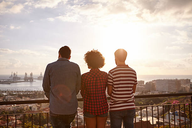 istock Three friends looking out over city 614969812