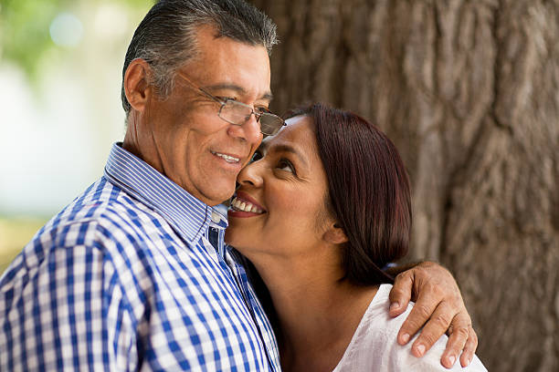 istock Playful mature latin couple next to tree 614972012