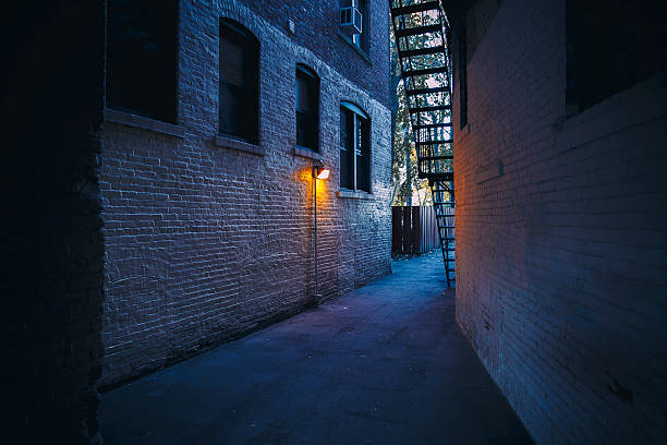 burning lantern in a dark alleyway