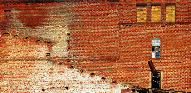 istock Red brick wall of old abandoned factory 614972538