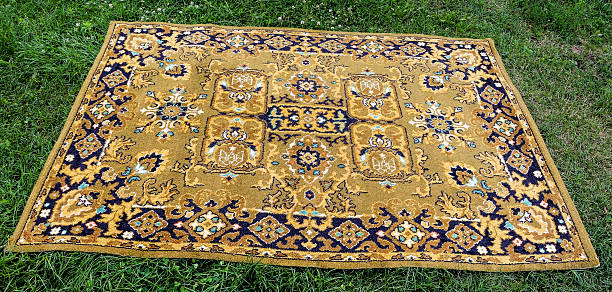 istock Old Persian rug on a green background 614973278