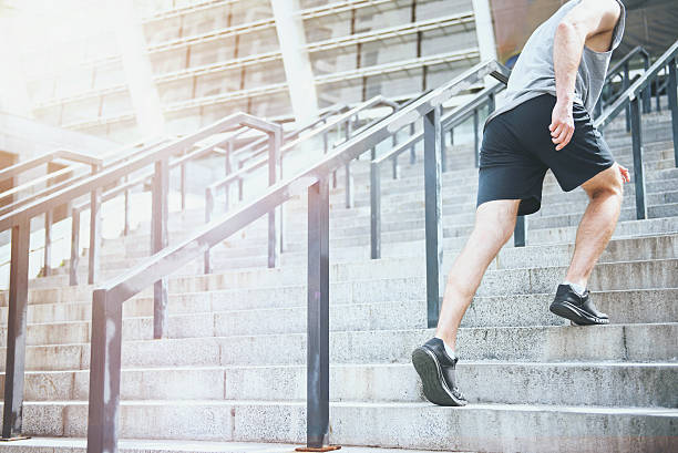 istock Active man climbing up the stairs in a sportswear 614975010