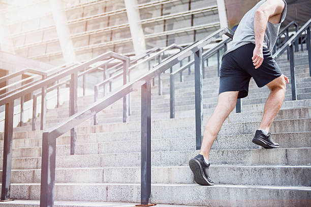 istock Active man climbing up the stairs in a sportswear 614975216